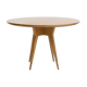 Round dining table in Wood Wood with brass details.