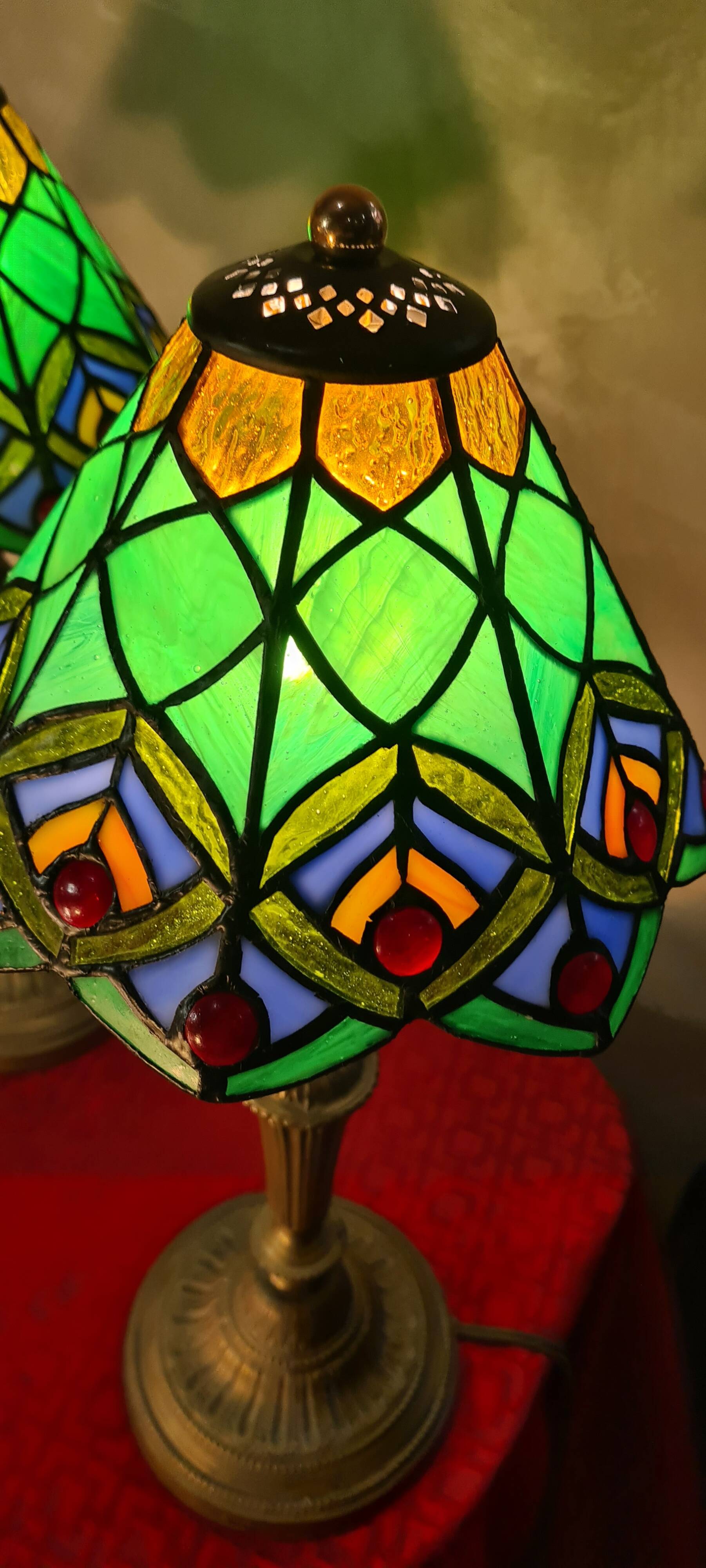 Pair of art nouveau bronze lamps, Tiffany-style glass lampshades