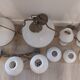 Lots of 1950s copper/ brass suspensions and wall lights with shades.