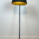 Design floor lamp in black lacquered metal and brass.