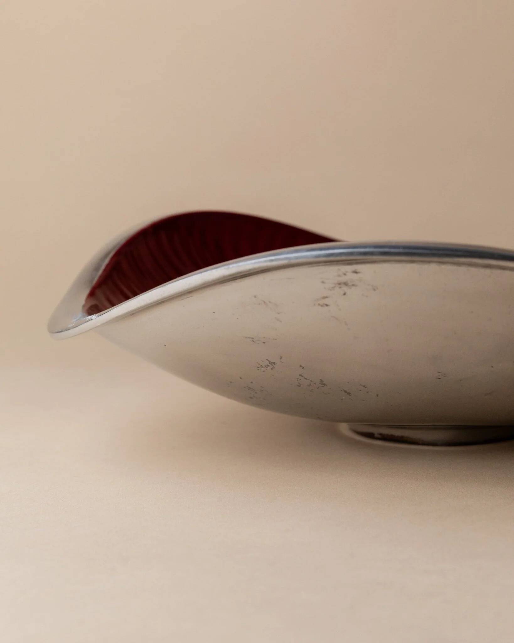 Red enameled steel bowl with textured interior and silver exterior; vintage Italian 1970s design