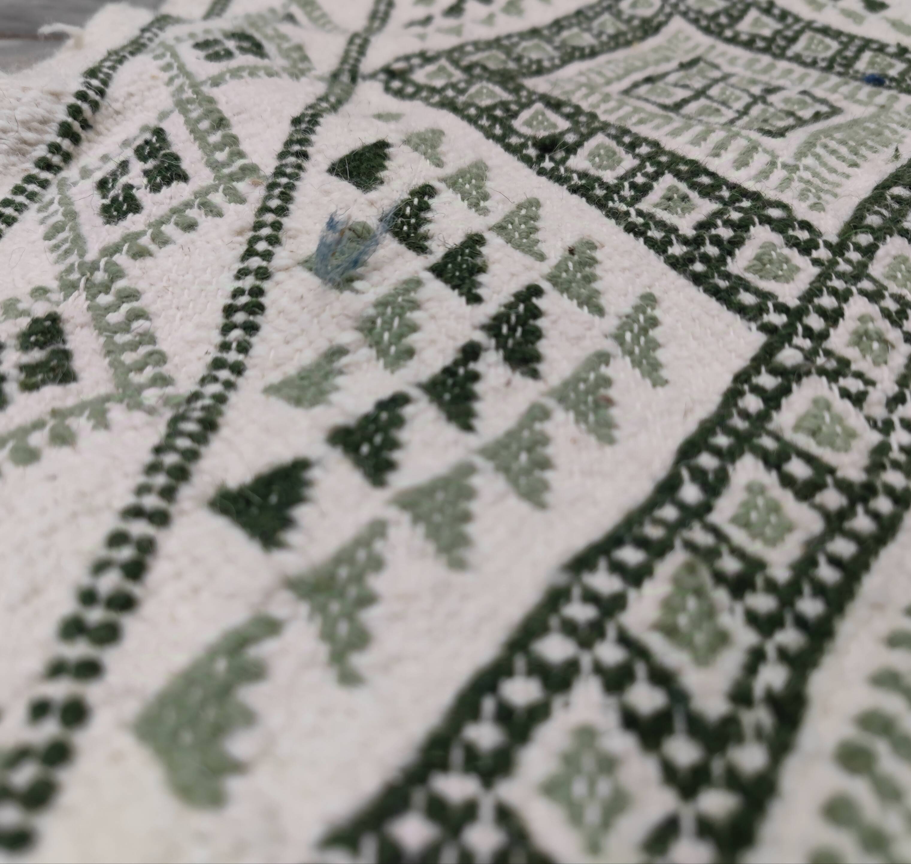 Handwoven white and green rug