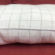 Beige linen cushion with checkered pattern and shiny silver piping