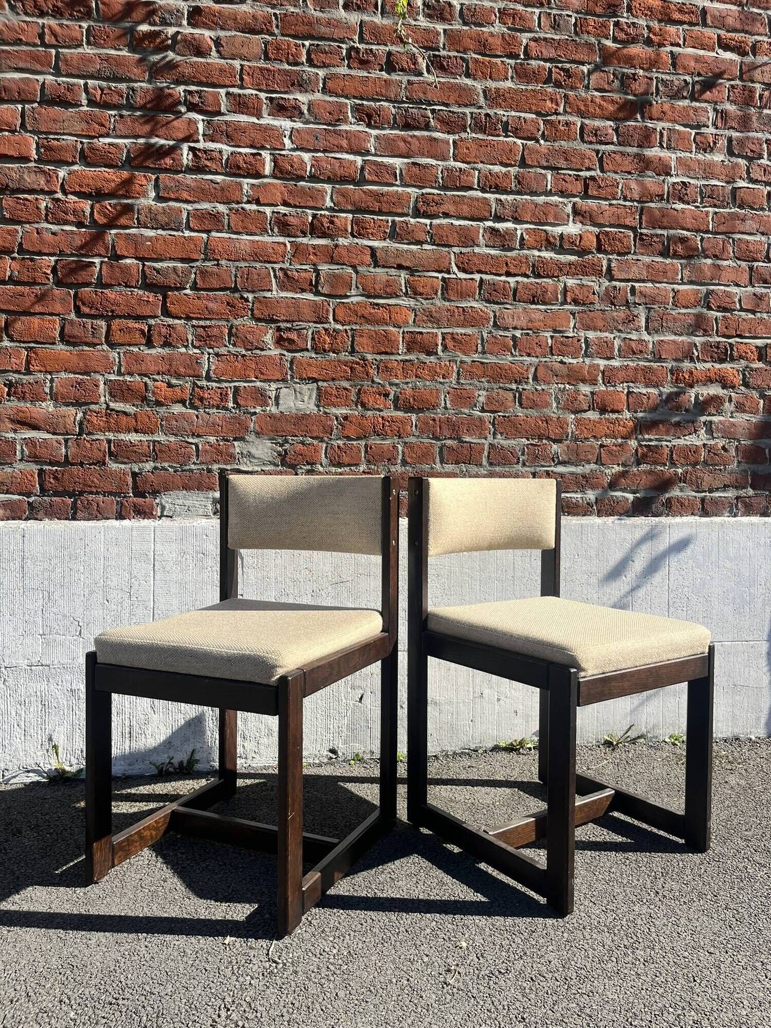 Many mid-century vintage wooden and fabric chairs.