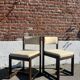 Many mid-century vintage wooden and fabric chairs.