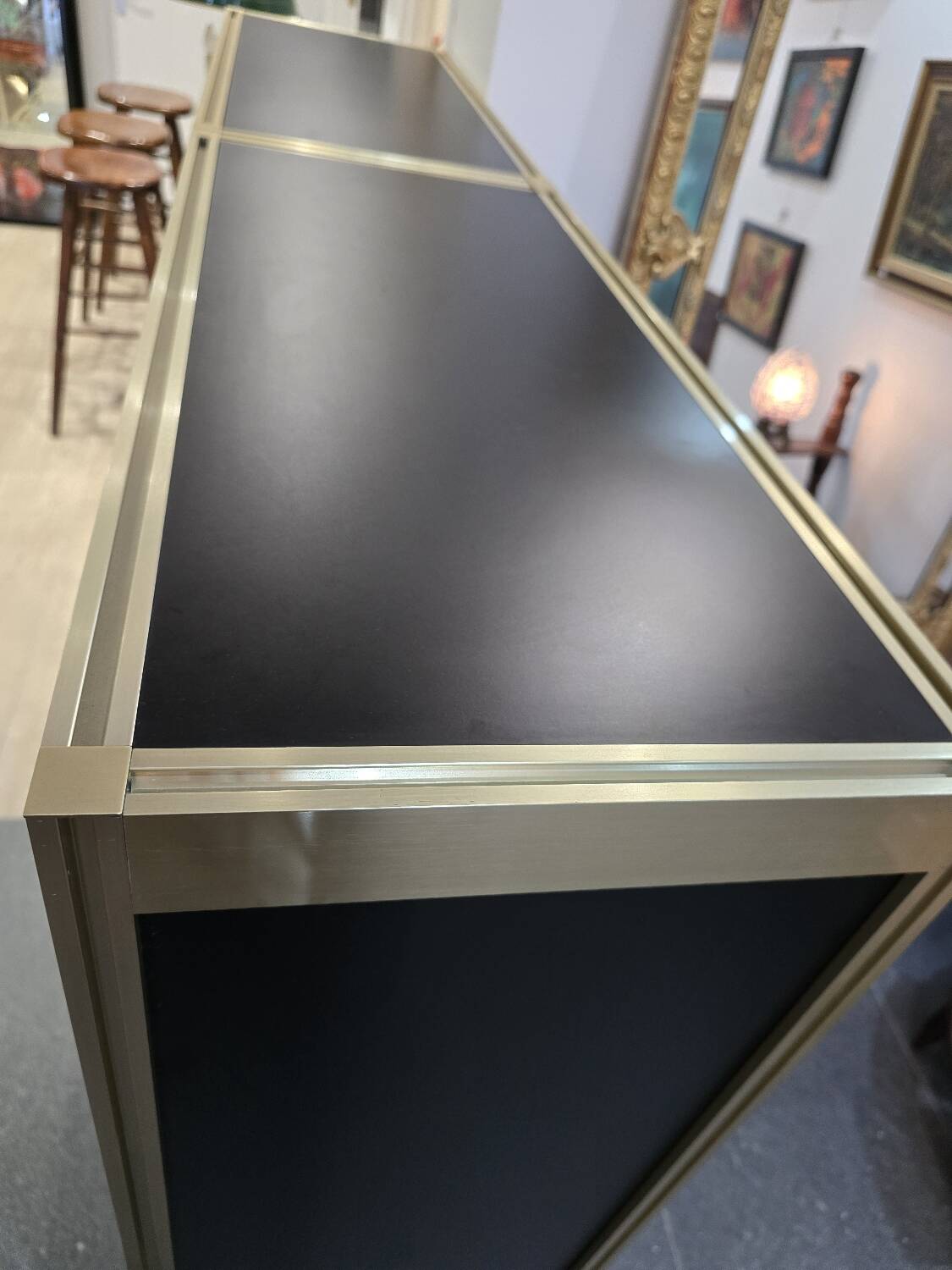 1970s design library with gold metal and lacquered wood.