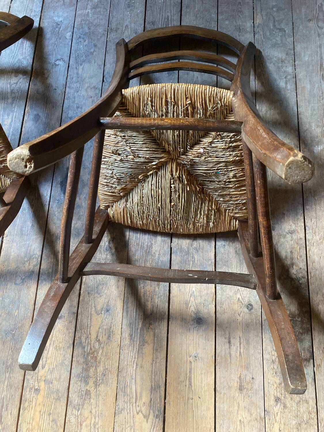 2 wooden chairs with cane