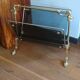 1950s bronze and tinted glass magazine rack with clawed feet