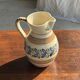Beige carafe with stylized blue flower friezes