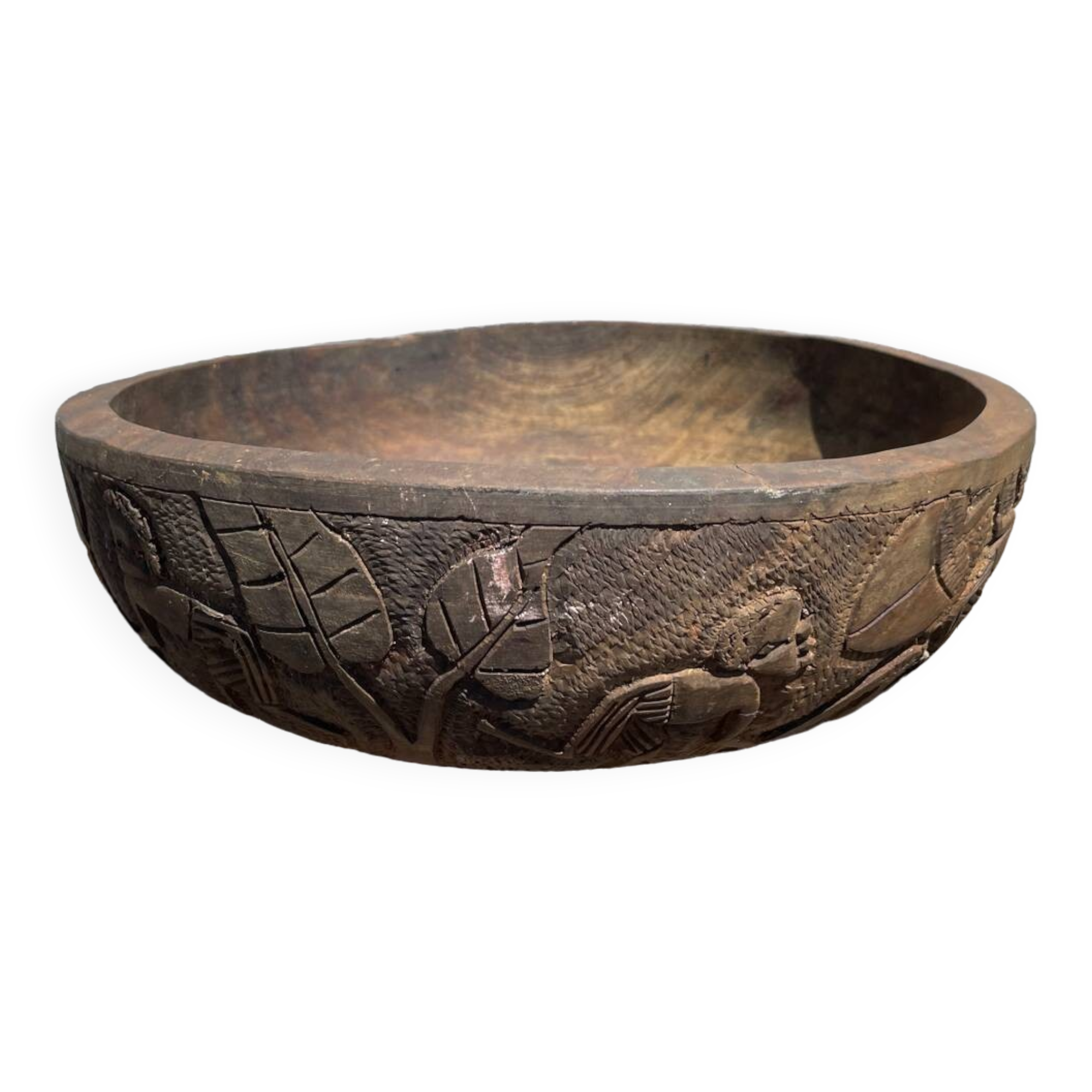Old carved wooden bowl with African decoration.