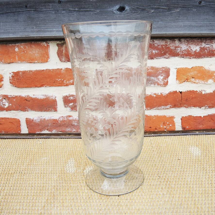 Ancient transparent glass vase with engraved plant decoration.