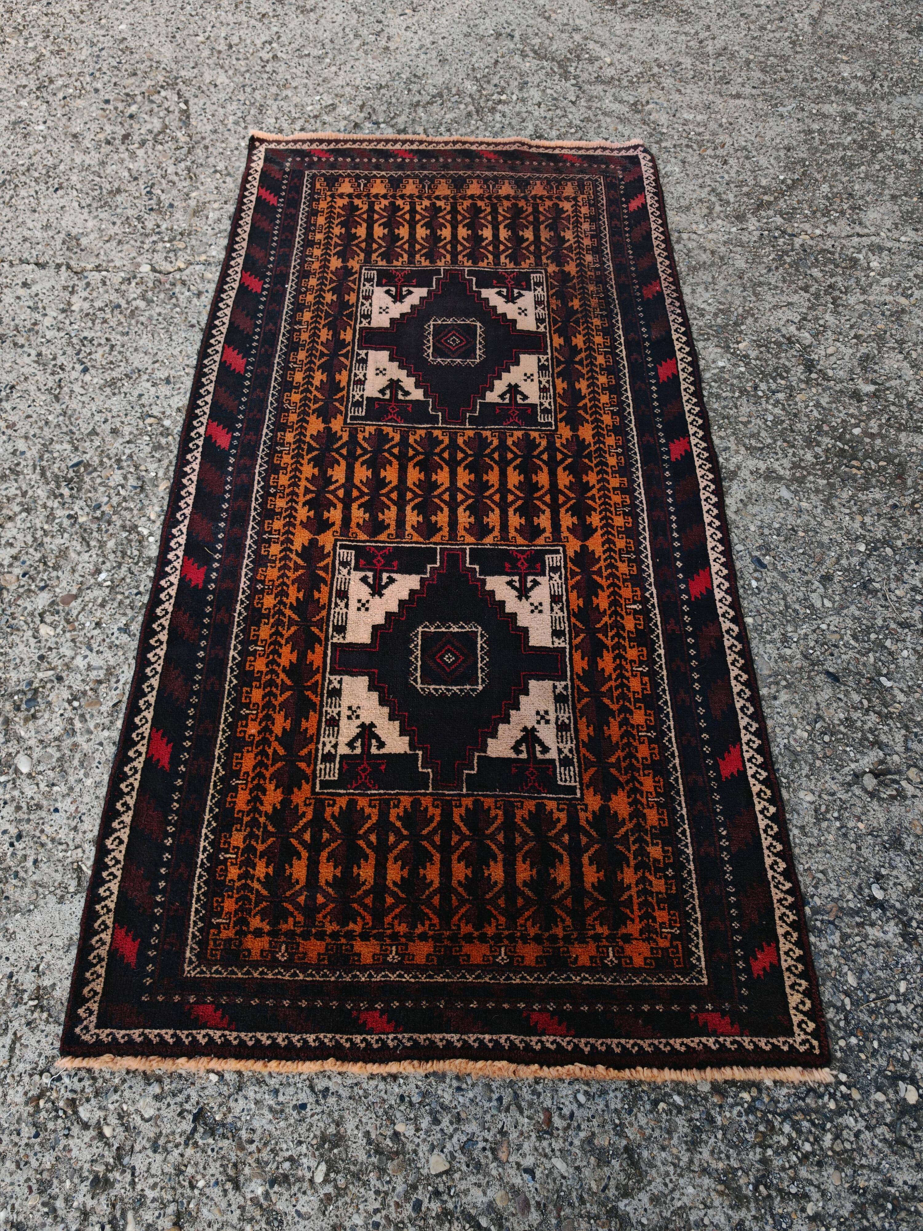 Vintage Persian Baluch rug, hand-knotted wool, 1970.