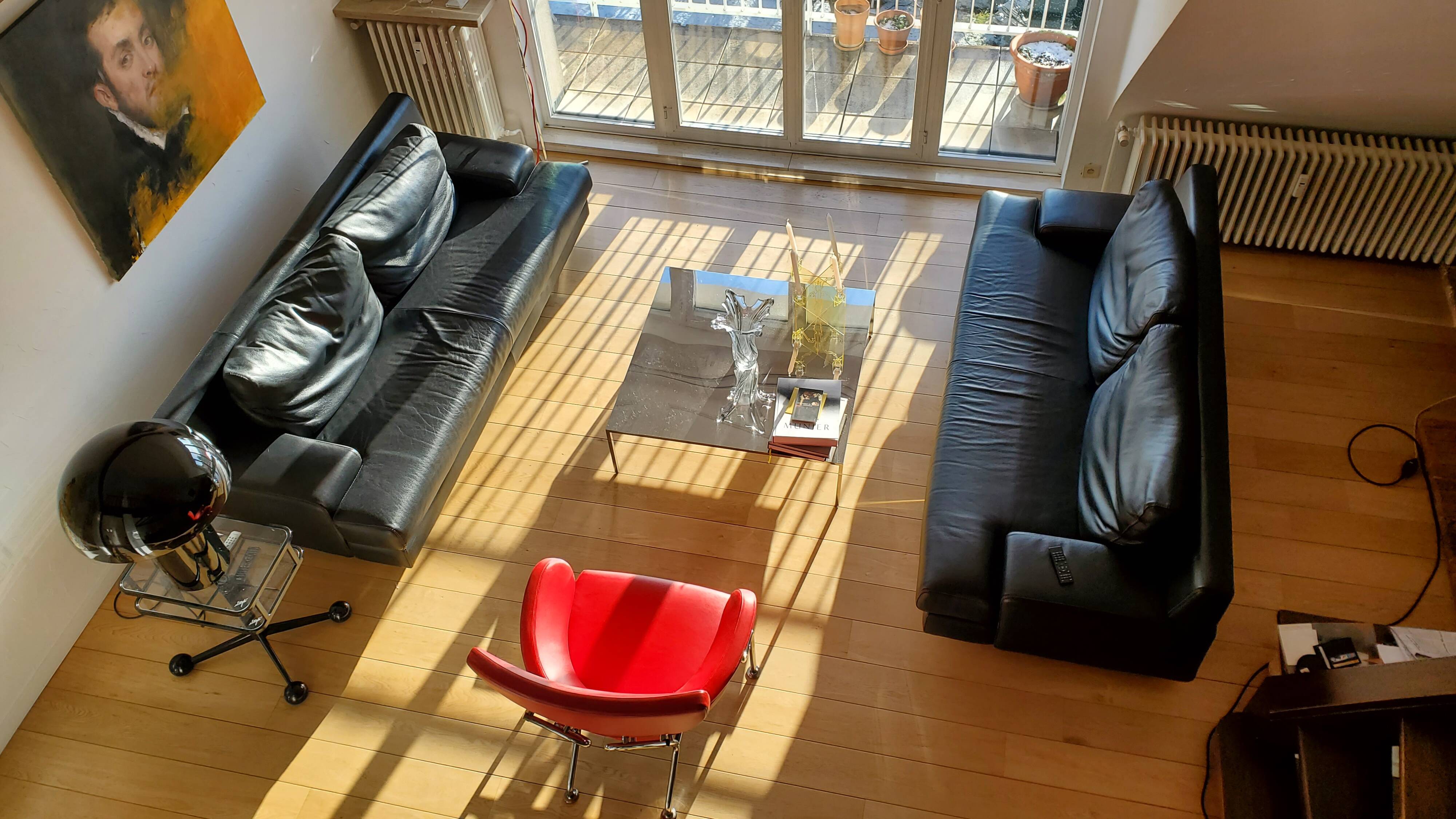 Black leather three-seater sofa