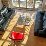 Black leather three-seater sofa