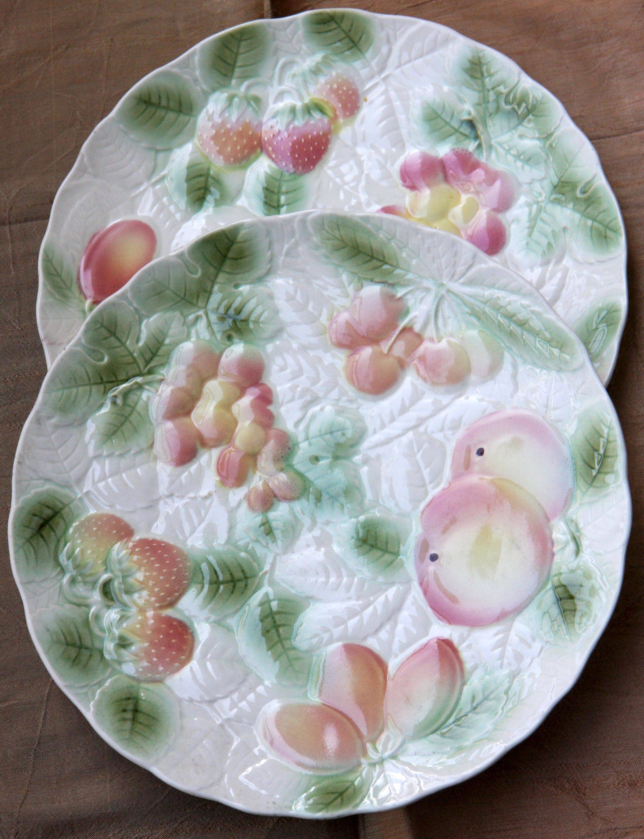 Two slip plates decorated with fruit.