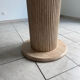 Round table with a travertine effect.
