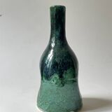 Ceramic vase with a glazed blue/green finish.