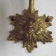 Simple wall sconce in French Art Nouveau bronze with a white glass shade featuring patterns.