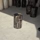 Small side table in black petrified wood with stripes and beige sides H28 D18.