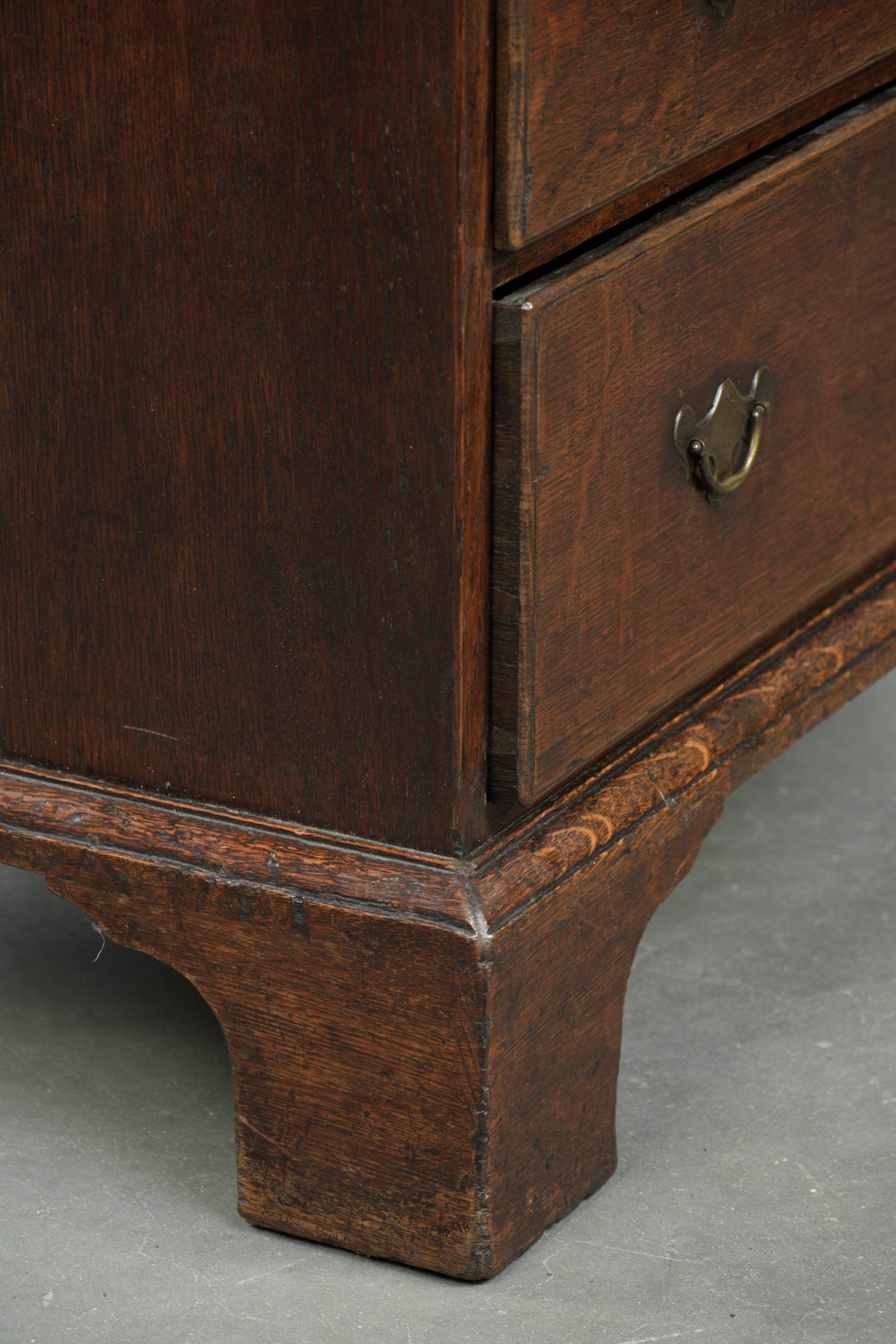 Antique English oak secretary from the 18th century with a stepped interior