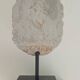Greek god statue in stone with a marble base.
