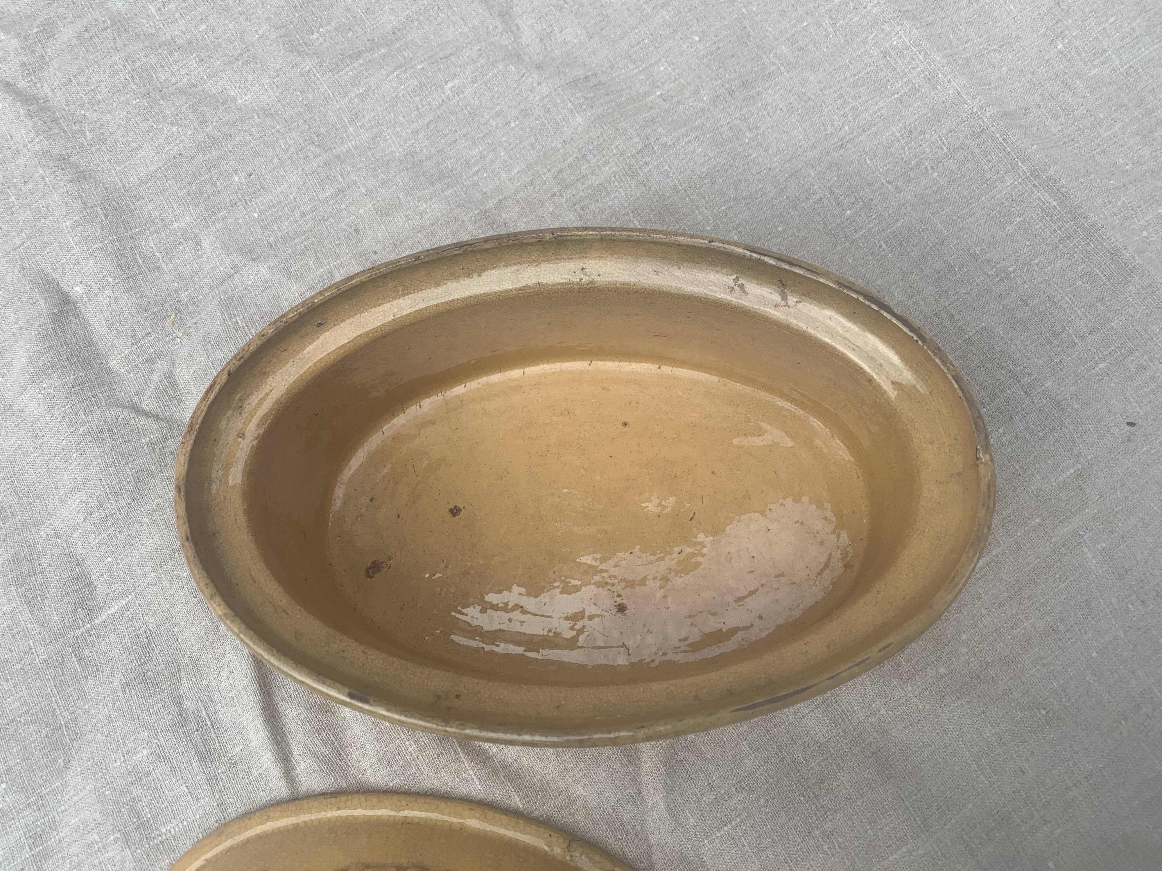 Old terrine in glazed stoneware and floral decoration mustard yellow slip