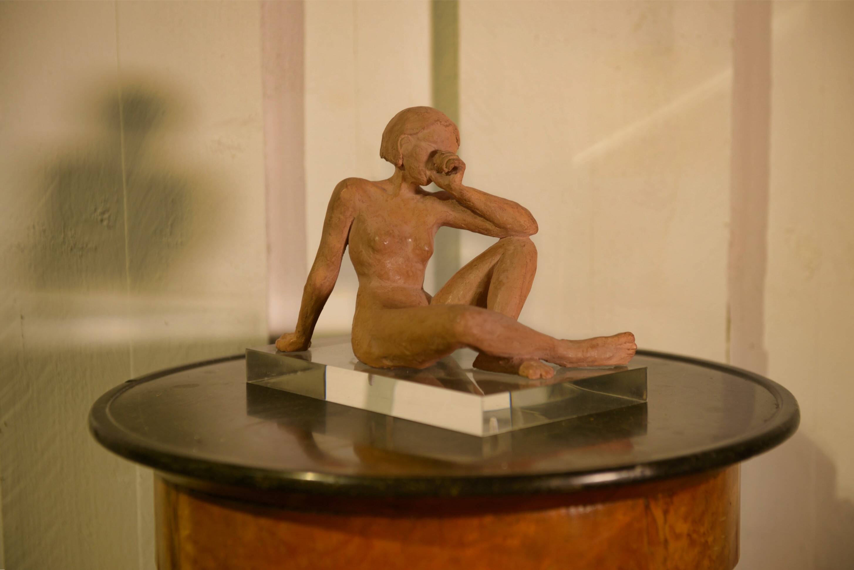 Terracotta sculpture of a seated woman by Norbert Treca contemporary art.