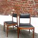 Set of 2 vintage Scandinavian chairs in wood and black faux leather.