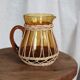 Amber glass and wicker carafe