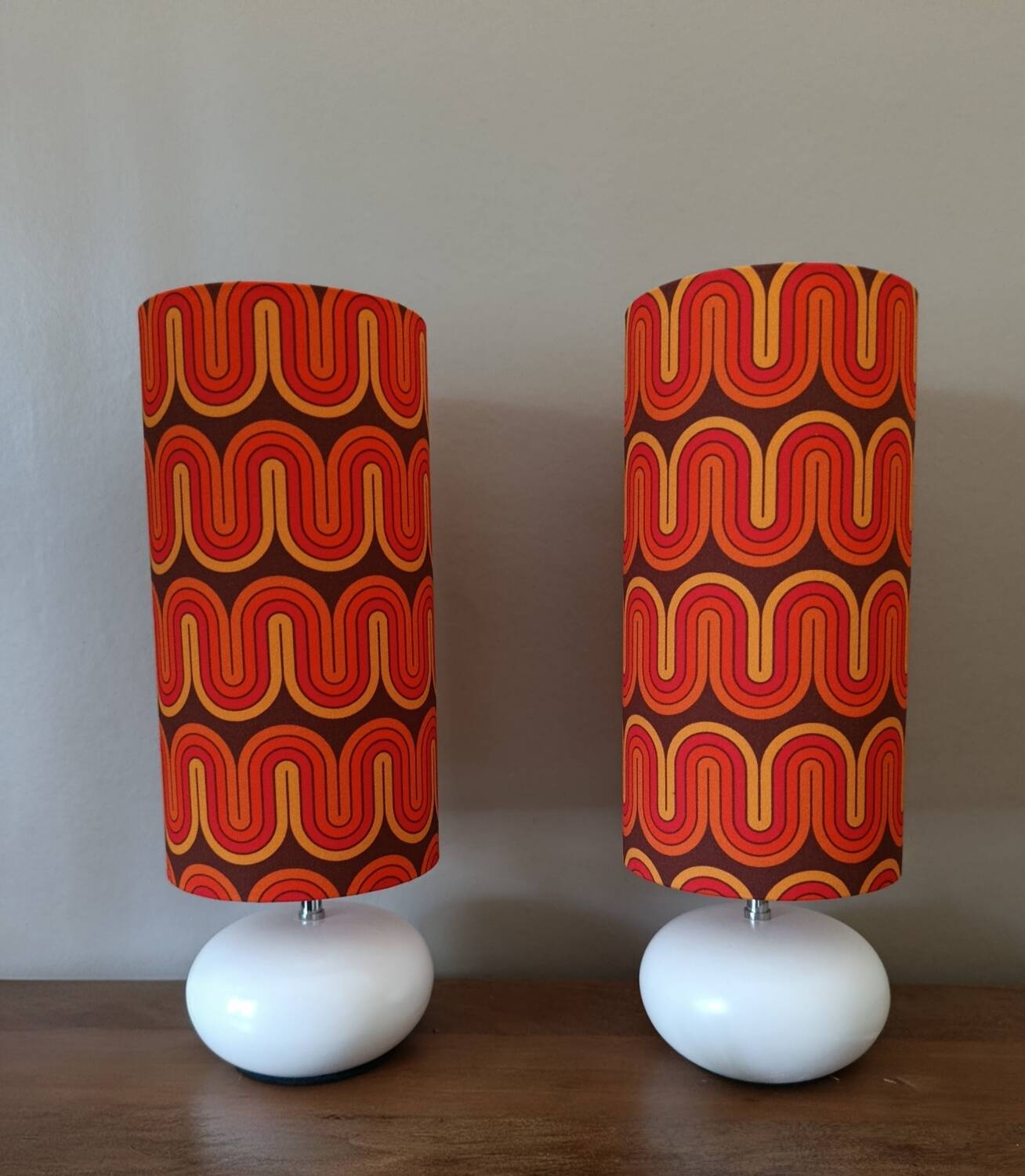 Two lamps with a seventies psychedelic wave print.