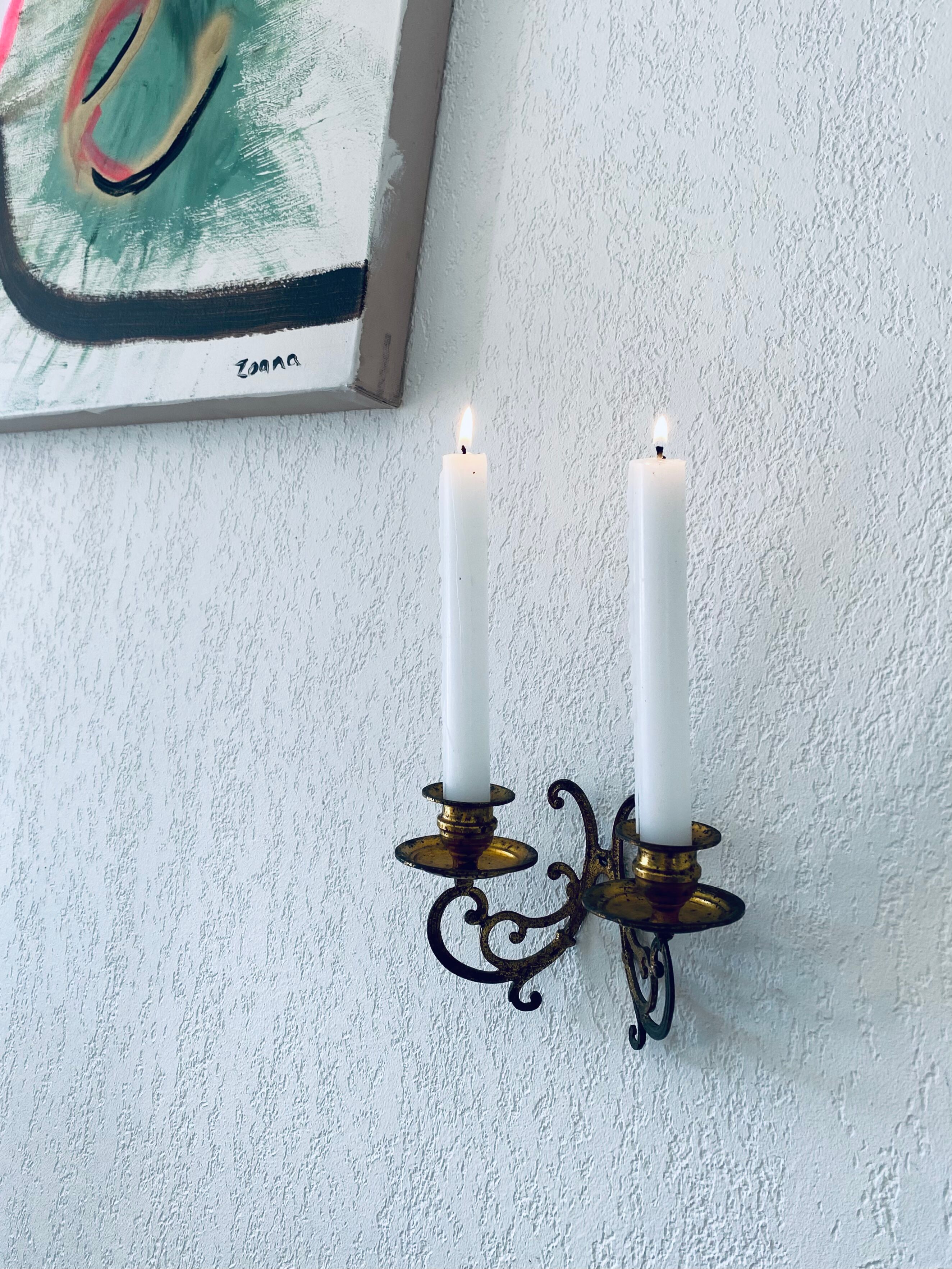Old wall candle holder in golden brass