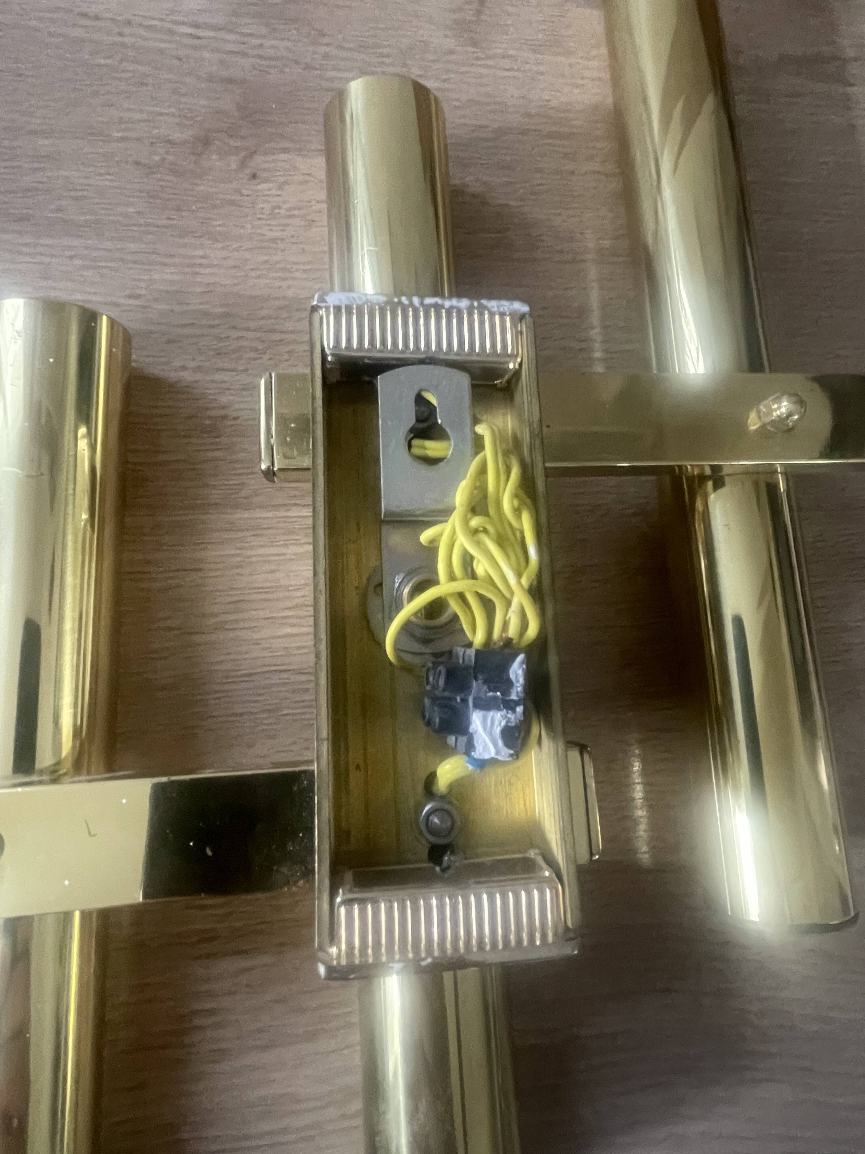 Tubular wall sconces in brass, Italian design from the 1970s, attributed.