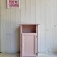 Antique bedside table revamped in pink.