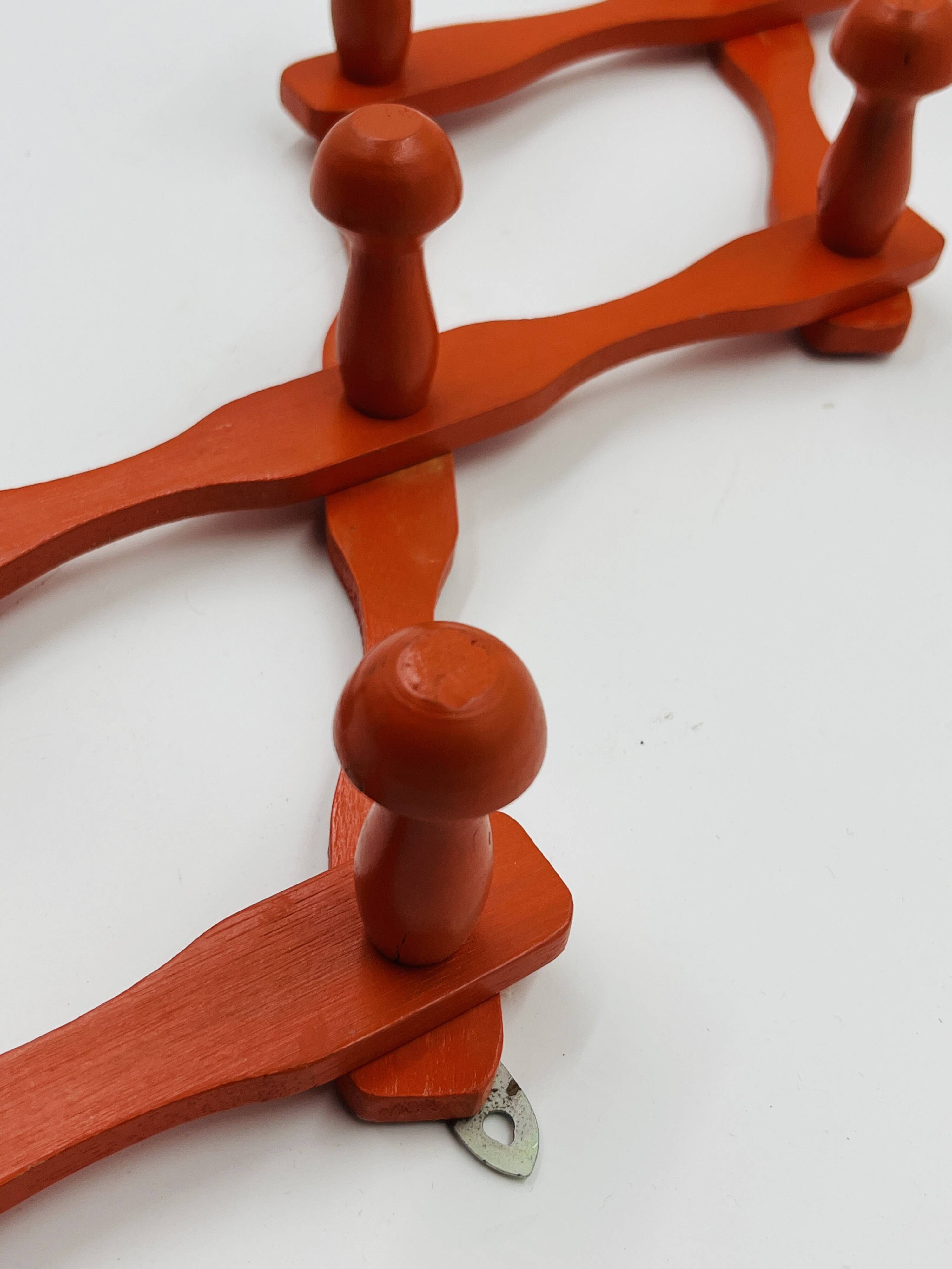 Vintage orange accordion coat rack