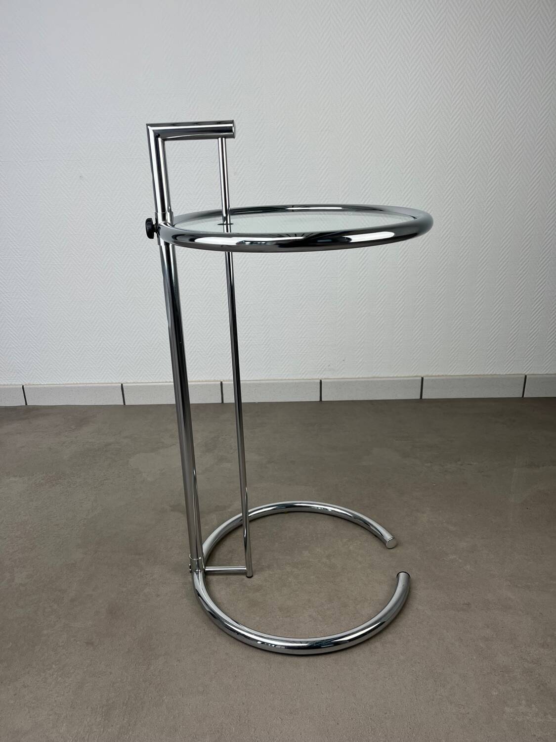 Chrome and glass design side table, adjustable.