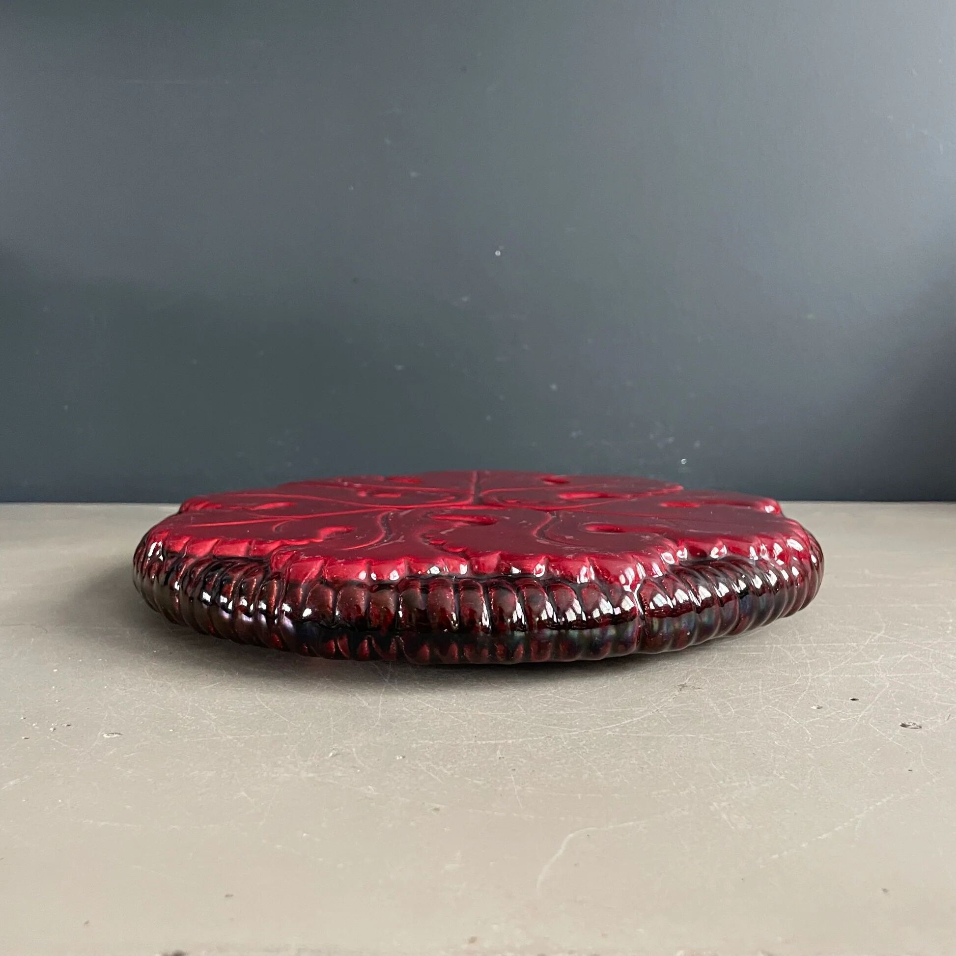 Burgundy ceramic trivet