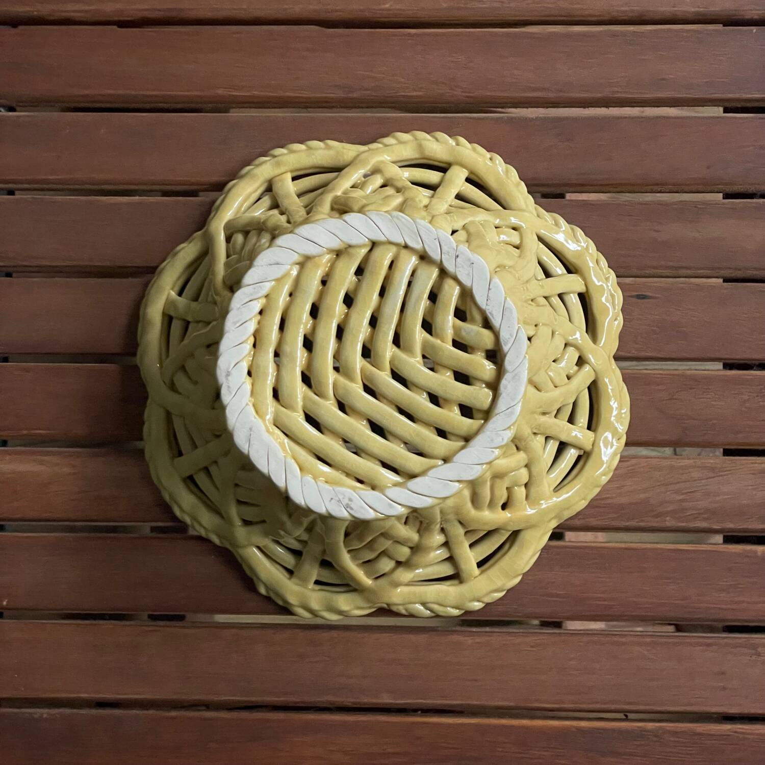 Yellow openwork woven earthenware basket