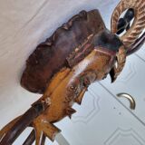 A large Senufo mask made of colored wood, decorated with an anthropomorphic figure