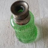 Small green bottle and old metal, single-flower vase