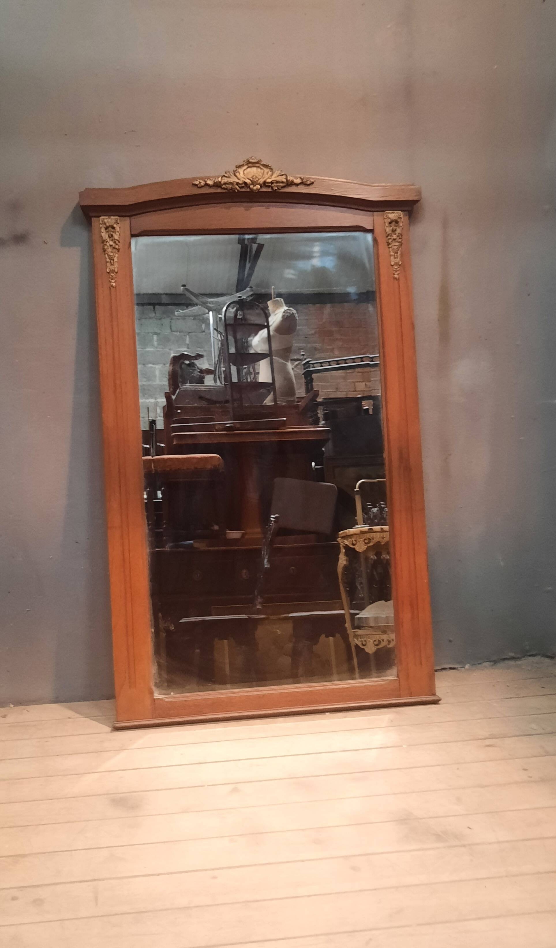 Bevelled mirror surrounded by a wooden frame.