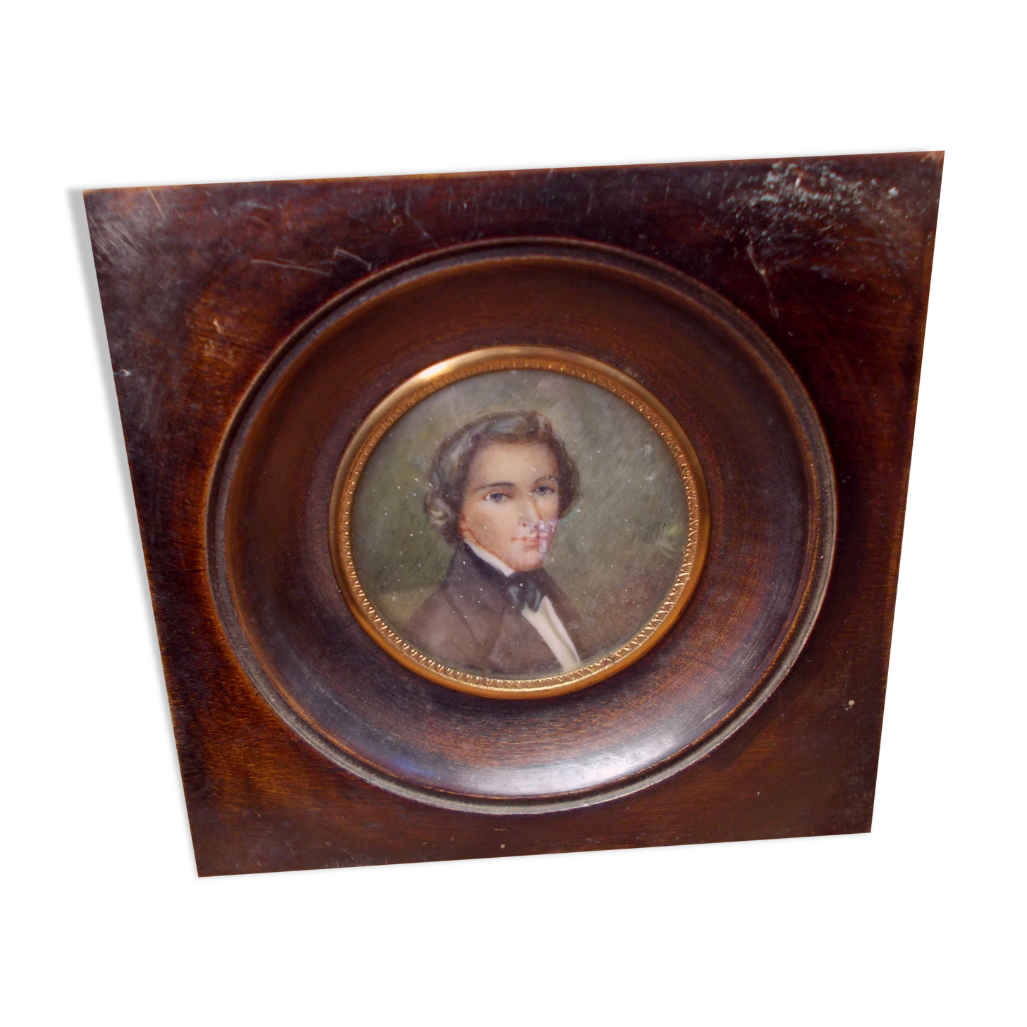 Miniature portrait of a man in a wooden frame