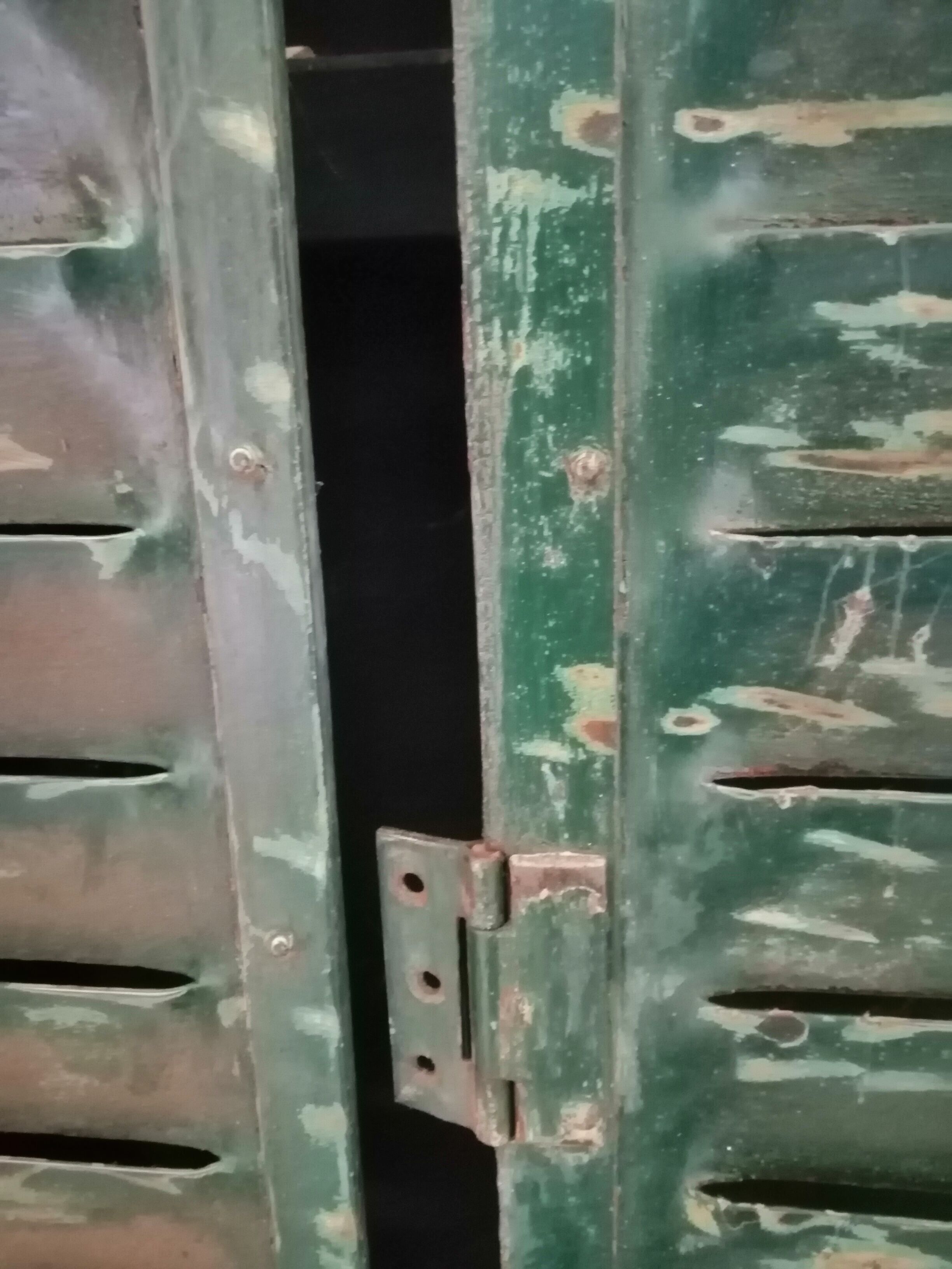 Lot of old green shutters in 4-part iron screen headboard