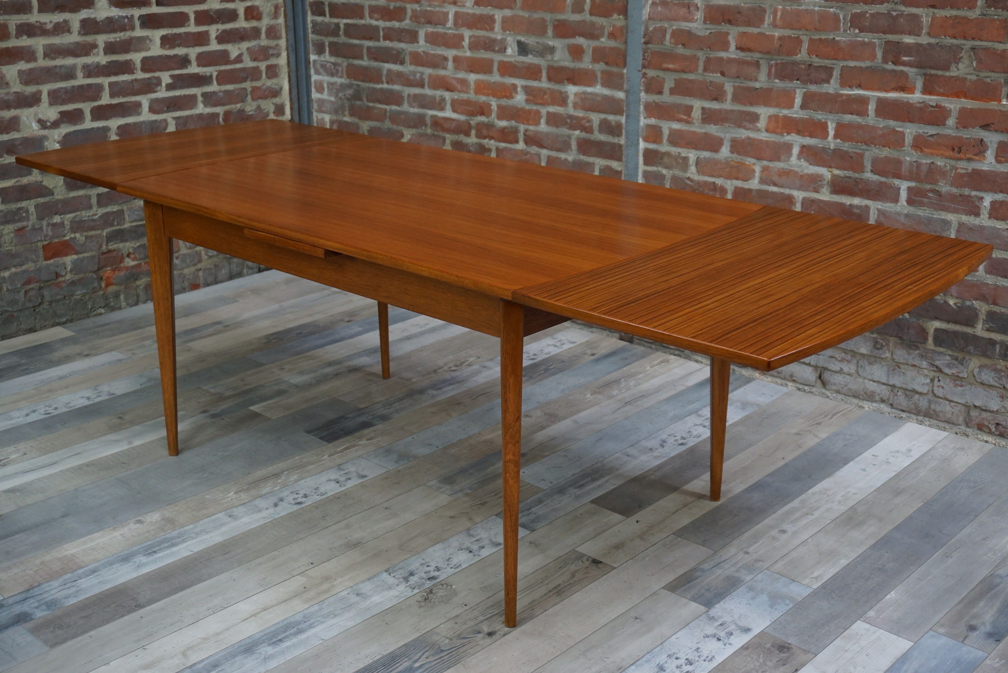 Teak dining table design by Johannes Andersen for Samcom 60s