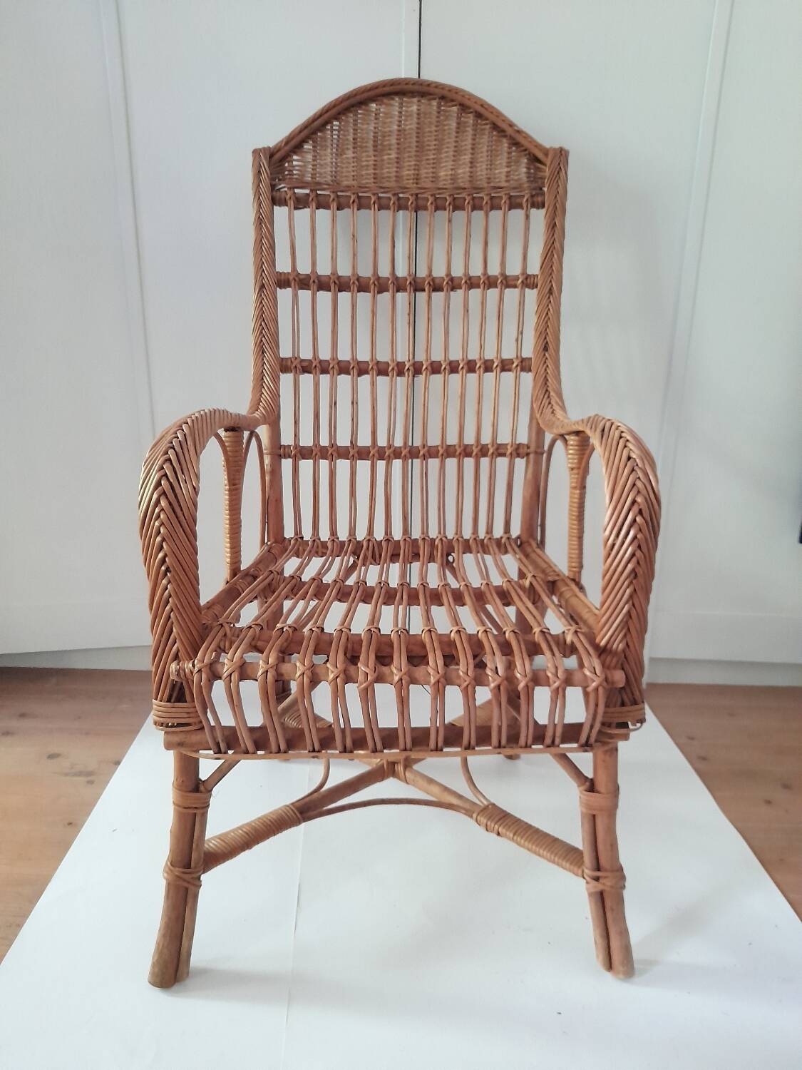 High-backed wicker armchair
