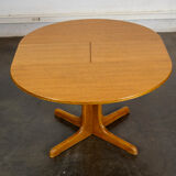 Round teak table with an extension.