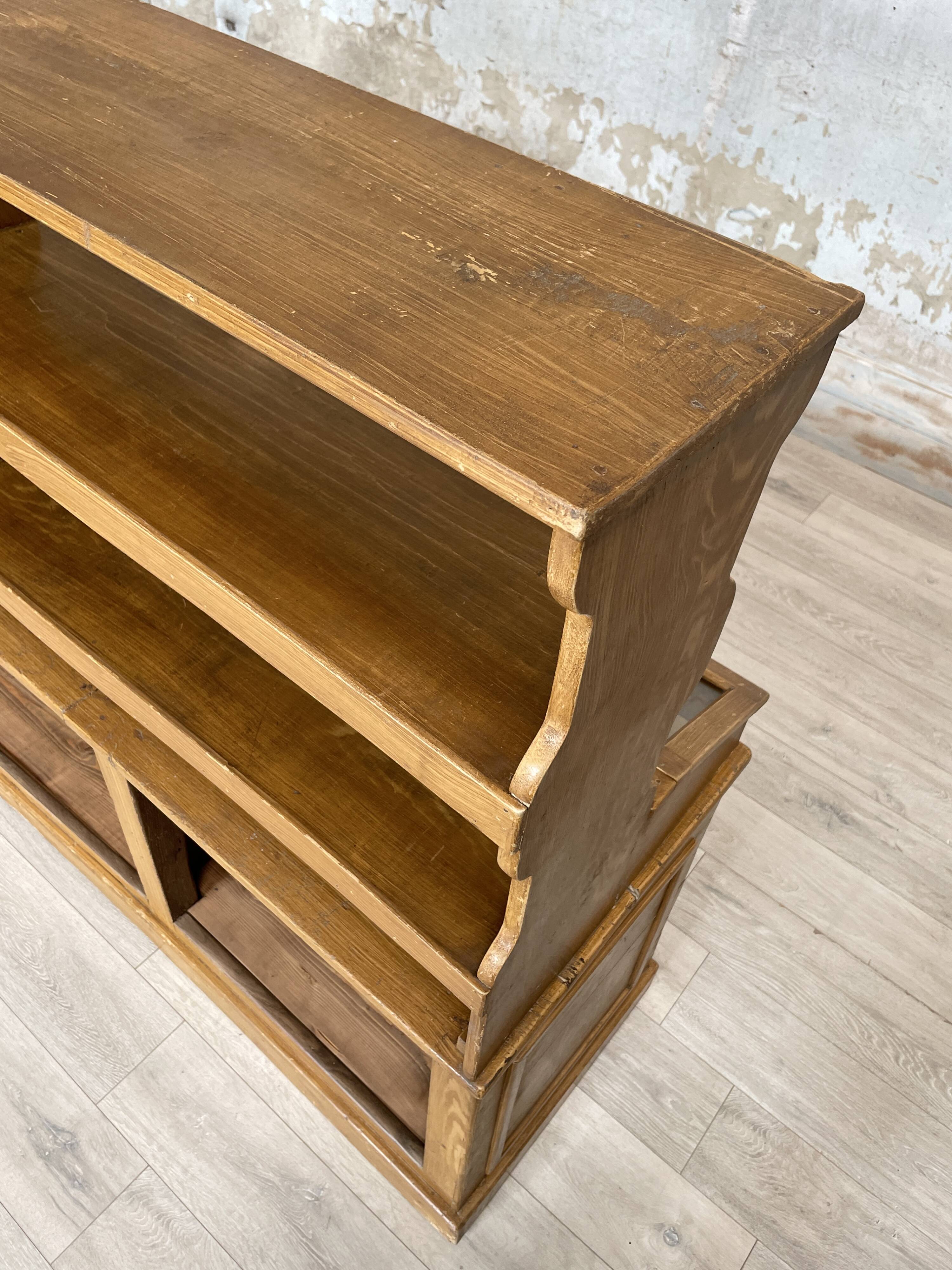 Wooden hardware cabinet painted with wood effect, circa 1940.