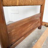 Brutalist style bed with chain and straw