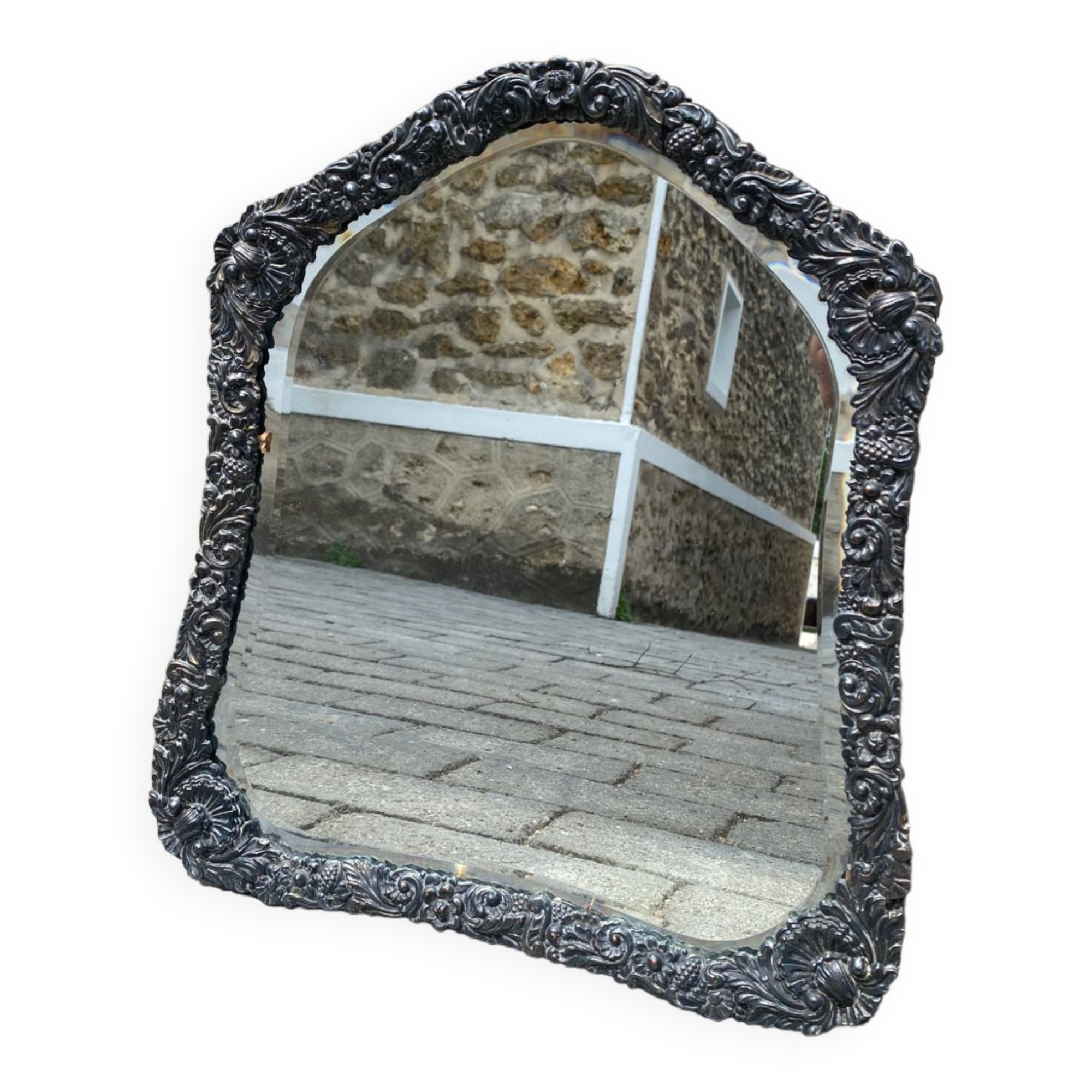 Old mirror carved in gray metal