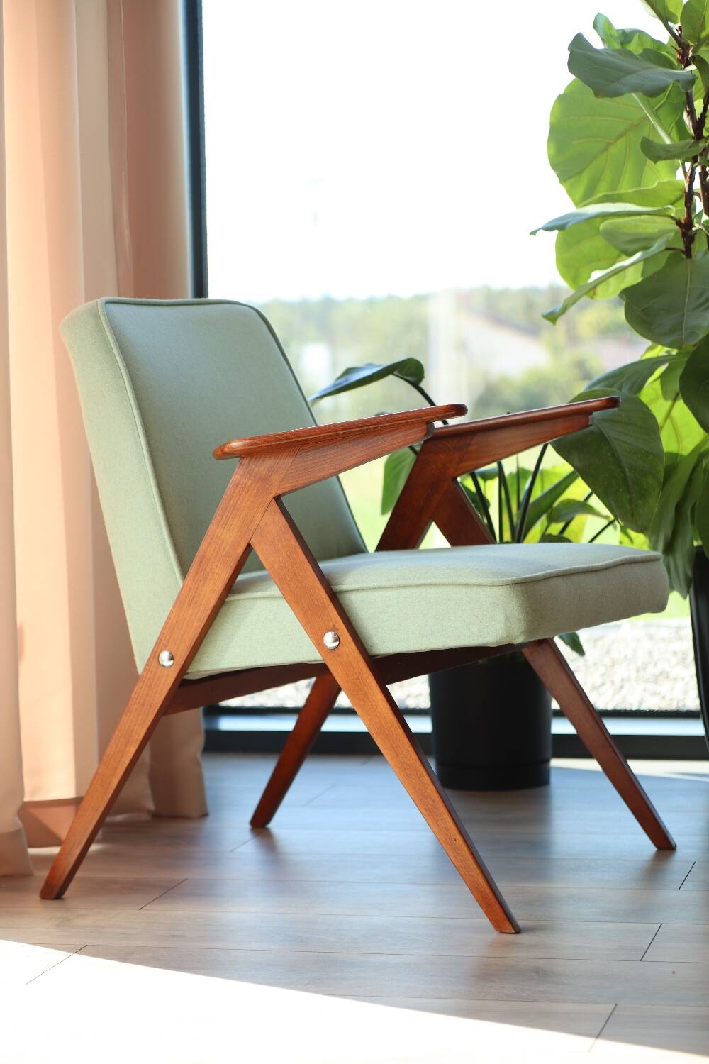 Vintage armchair in mint green wool, mid-century modern design.