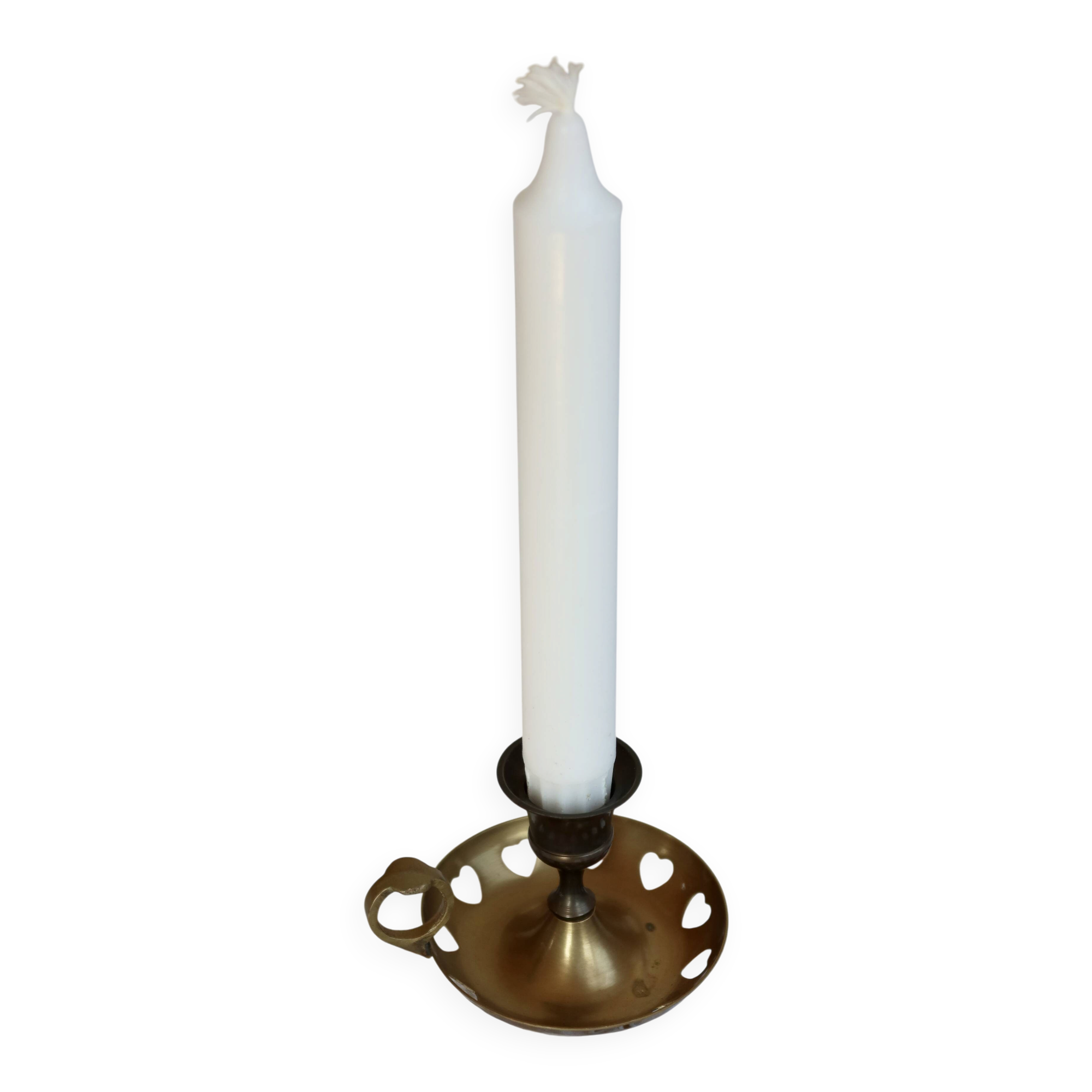 Antique brass rat trap with heart patterns.